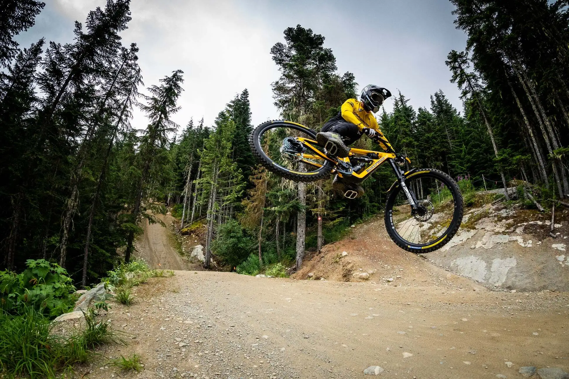 Nukeproof Mega enduro mountain bike in the air during a jump in the bike park